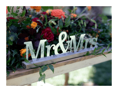 A wooden sign with the words mr and mrs.