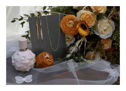 A bouquet of flowers and jewelry on a table.