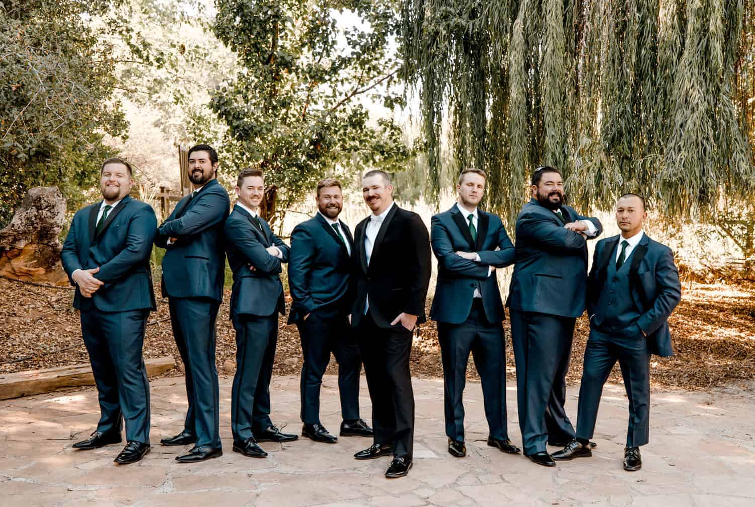 A group of groomsmen posing for a photo.