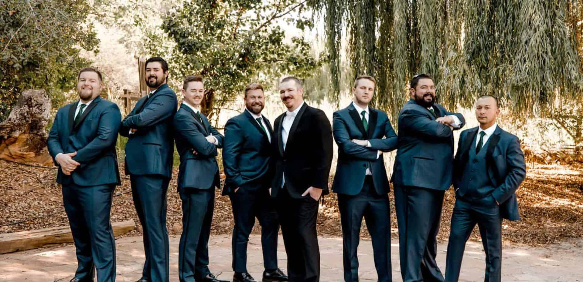 A group of groomsmen posing for a photo.